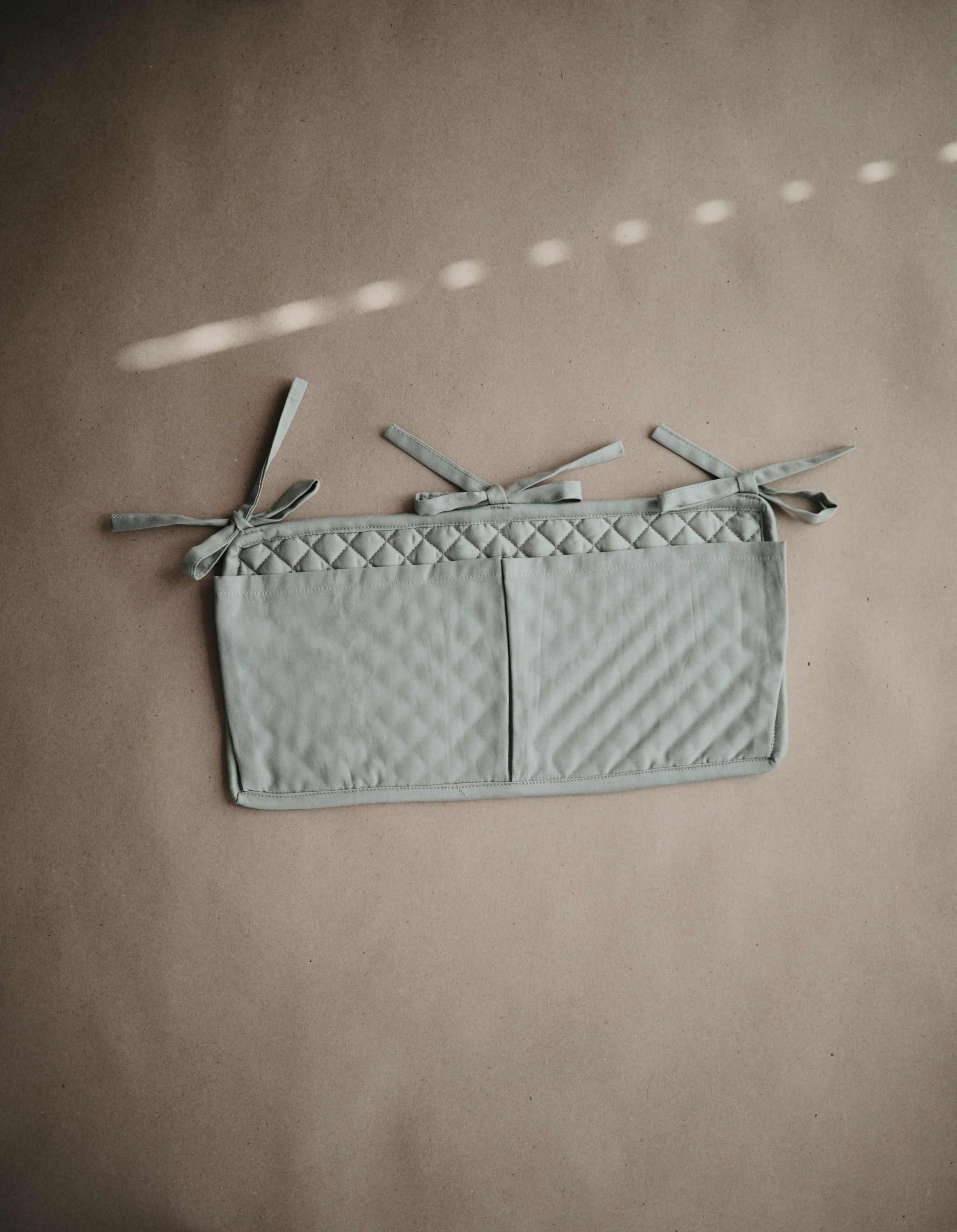 Mushie lovytės kišenė „Crib Pocket“ – Roman Green